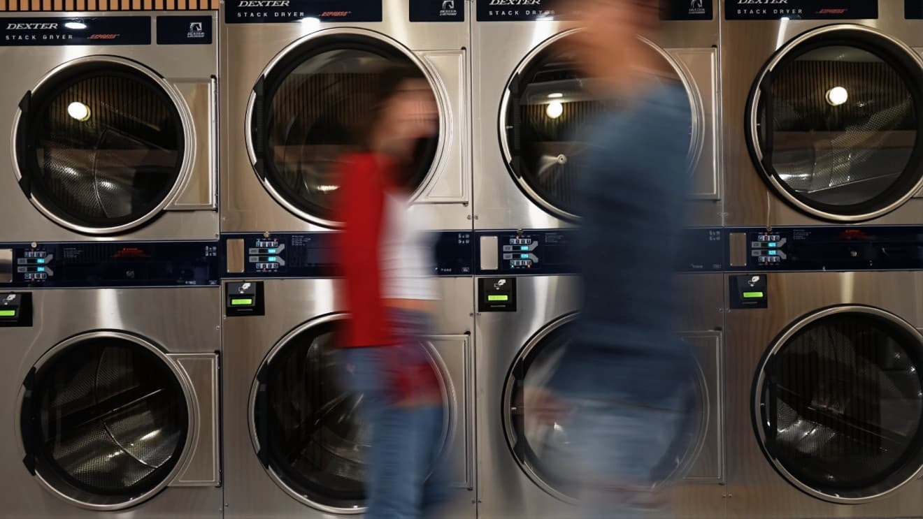 Wash and Fold Express laundry team at commercial dryers
